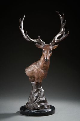 a bronze sculpture of a deer with antlers on it ' s head