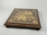 a close up of a small wooden box with flowers on it