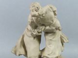 statue of a man and a woman kissing on a rock