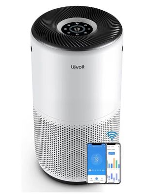 a white and black air purifier next to a cell phone