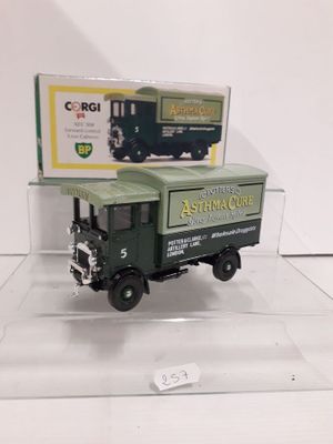 a green toy truck with a box on top of it