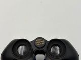a close up of a pair of binoculars on a white surface