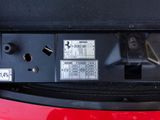 a close up of a red car ' s front bumper