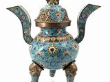an image of a blue and gold teapot on a stand