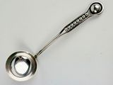a silver spoon with a metal handle on a white surface