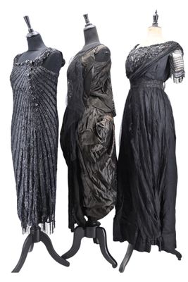 three dresses on a mannequin stand on a white background
