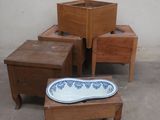several pieces of furniture sitting on a cement floor next to a white wall