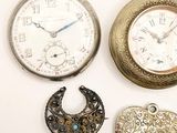 three different types of pocket watches are displayed on a white surface