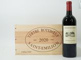 a bottle of wine sitting next to a wooden box
