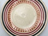 two plates with different designs on them sitting on a table