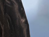 a close up of a man ' s black suit with a tie