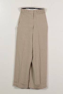 a close up of a tan pants hanging on a hanger