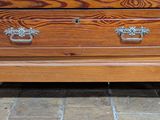 a wooden chest of drawers sitting on a tile floor