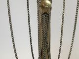 a close up of a metal lamp with chains on it