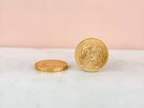 a close up of a coin sitting on top of a counter next to a coin