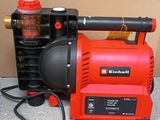 a red and black blow dryer sitting on the ground