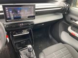 the interior of a car with a touch screen and a steering wheel