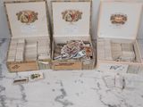 four boxes of cigars are lined up on a marble surface