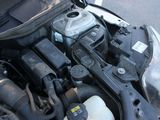 the engine of a car with its hood open on the street