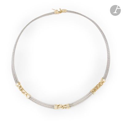 a gold and silver necklace on a white background