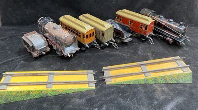 several toy trains are lined up on a black surface