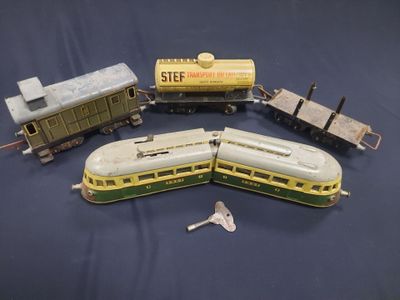 four toy trains that are sitting on a blue surface