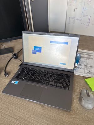 a laptop computer sitting on a desk next to a computer monitor