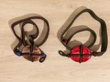 two necklaces that are on a wooden table