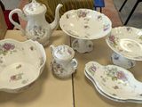 a table that has a lot of dishes and cups on it
