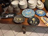 many plates and bowls on a table in a room