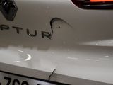 the rear end of a white car with a sticker on it ' s bumper