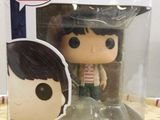 a close up of a pop vinyl figure in a box on a table