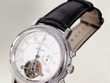 a watch that is sitting on a black leather strap