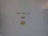 a white plate with gold writing on it