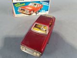 a toy car that is sitting next to a box