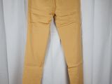 a pair of yellow pants hanging on a white curtain