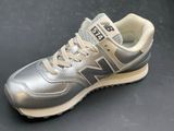 the new balance 995 is a grey and beige sneak with a white sole
