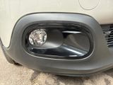 a close up of a car ' s front bumper with a light on