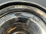 a close up of a silver plate with a hole in it