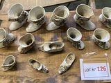 a lot of small cups on a table with a price tag