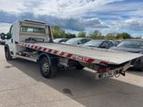 a flatbed truck that is parked in a parking lot