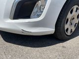 a close up of a car ' s front bumper with a denting on it