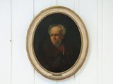 un tableau représentant un homme vêtu d'un manteau rouge, accroché au mur