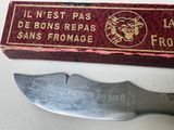 a knife sitting next to a box with a label on it