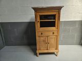 a small wooden cabinet with a glass door on it
