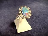 a close up of a ring with a fire opal in it