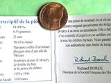 a picture of a piece of paper with a penny on it