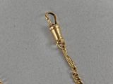 a close up of a gold chain with a clasp on it