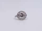 a diamond and white gold ring set with a round brilliant cut diamond