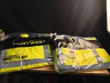 two bags of luggage sitting on a table in front of a black backdrop